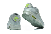 Rear and outsole views of Nike Air Max 90 QS sneakers with lime heel logos.