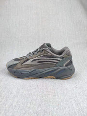 Side profile of the gray sneaker showing the panel construction and sculpted sole.