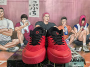 Front view of paired red and black Adidas basketball sneakers with black laces, padded tongues and visible Adidas branding.