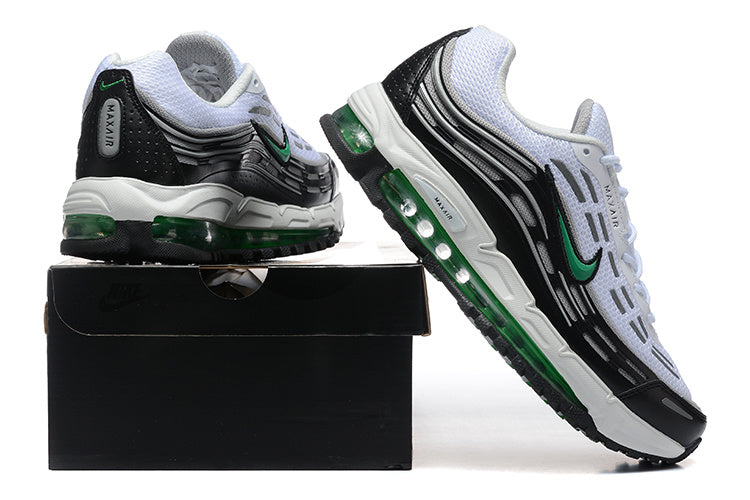 White, black, and green Nike sneakers shown from the heel and side on a black shoe box.