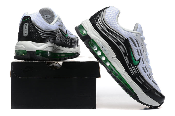 White, black, and green Nike sneakers shown from the heel and side on a black shoe box.