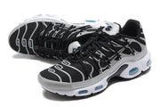 Angled view of Nike Air Max Plus sneakers showing patterned black uppers, grey overlays, and visible sole cushioning