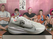 White Nike basketball shoe shown from the side with mesh-patterned panels and dark swoosh detailing.