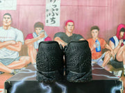 Rear view of the black basketball sneakers showing textured heel panels and the patterned outsole.