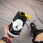 Rear view showing the padded collar, white heel panel, Jordan logo, and yellow hangtag.