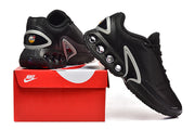 Black Nike sneakers displayed on a red shoe box, showing the side and heel
