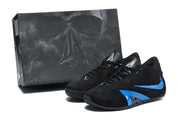 Black and blue low-top sneakers beside a dark branded shoe box