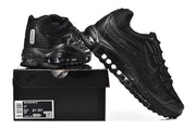 Black Nike Air Max 97 OG sneakers displayed with a shoe box