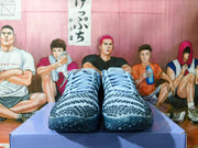 Front view of the pair showing blue laces, patterned uppers, and blue outsoles.