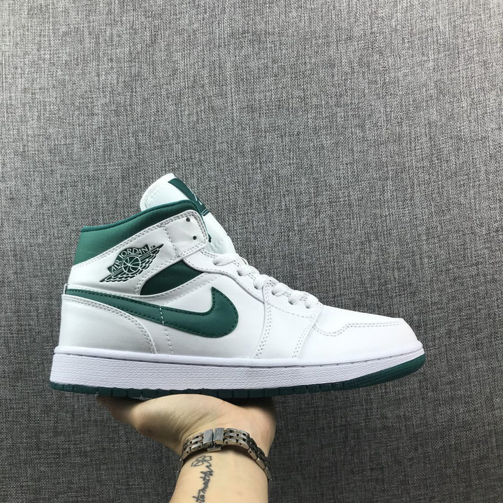 Side profile of a white and Mystic Green Jordan mid-top sneaker.