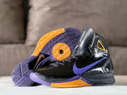 Black Nike basketball shoe with purple and gold patterned outsole visible