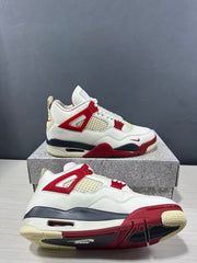 Air Jordan 4 Retro sneakers shown from the side in white with red and dark navy accents, displayed on a shoe box.