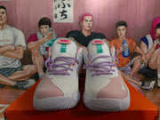 Front view of white Nike basketball shoes with pink toe panels, purple laces, and turquoise tongue details