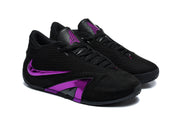 Pair of black low-top shoes with purple details, angled front view