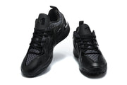 Front and angled views of black sneakers showing the patterned tongue panels and lace-up design.