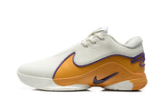 Side profile highlighting the perforated white upper, gold-orange midsole panels, and purple Nike swoosh.