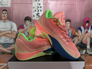 Angled view of pink Nike basketball shoes with lime-green accents and navy outsoles