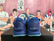 Rear view of navy Nike Kobe basketball shoes with aqua outsoles and signature detailing