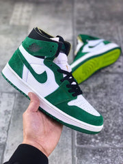 Angled front view showing the green toe overlay, white perforated toe box, and black laces.