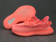 Pair of pink sneakers shown with one sole turned upward, revealing the outsole pattern and translucent construction.