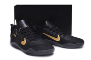 Black and gold Kobe 11 sneakers displayed against a black background.