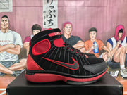 Side view of a black and red high-top sneaker showing the red side swoosh-style detail, ankle panel, and layered outsole.