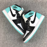 Angled pair view highlighting the mint green collars and heel panels against the black and white upper.
