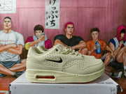 Side view of a beige Nike sneaker with perforations, Swoosh detail, and visible heel Air unit