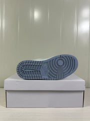 View of the blue-grey rubber outsole with circular traction grooves and patterned tread.