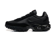 Side view of black Nike Air Max Waffle SP sneakers showing the Swoosh and sculpted midsole.