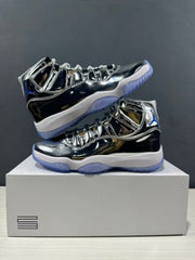 Pair of reflective silver and black high-top sneakers displayed on a white box from opposite side angles.