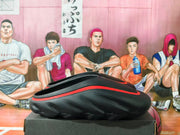 Side view showing the black clogs' sculpted soles and red accents.