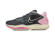 Side profile of a charcoal, pink, and cream Nike Kyrie shoe