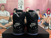 Rear view of black high-top sneakers with Air branding and a blue-tinted outsole.
