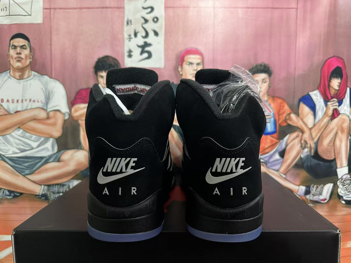 Rear view of black high-top sneakers with Air branding and a blue-tinted outsole.