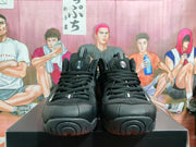 Front view of black high-top sneakers with laces and small white accents
