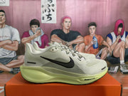 Side view showing the gray textured upper, black Swoosh, and light yellow-green midsole with visible AIR ZOOM text.