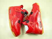 Red high-top sneakers shown from the side, highlighting the molded side supports, visible air units, and gum-colored outsole.