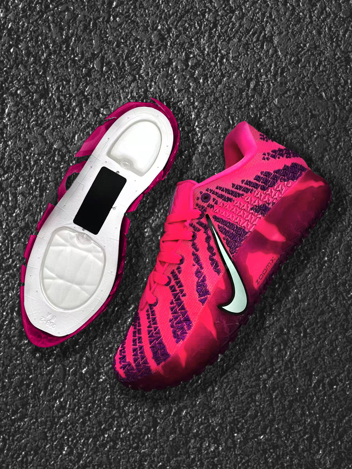 Pink and purple Nike basketball sneakers shown from above, including one shoe with the sole exposed.