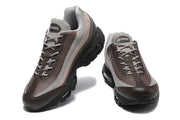 Front and angled views of Nike Air Max 95 sneakers with A Ma Maniére tongue labels