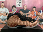 Side view of a rose-gold and black Nike sneaker showing sculpted side detailing, a visible Swoosh, and a light outsole.