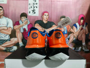 Rear view of orange Nike basketball shoes showing GT heel markings and white outsoles