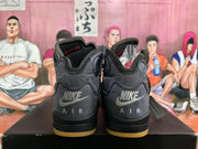 Rear view of grey and black high-top sneakers showing Nike Air branding, padded collars, and translucent yellow outsole accents.