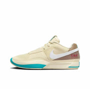 Cream basketball sneaker with a white Swoosh, brown heel panel, and turquoise outsole accents.