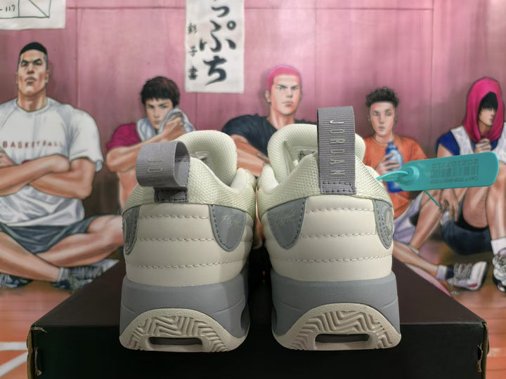 Rear view of beige sneakers with gray heel details and sculpted soles