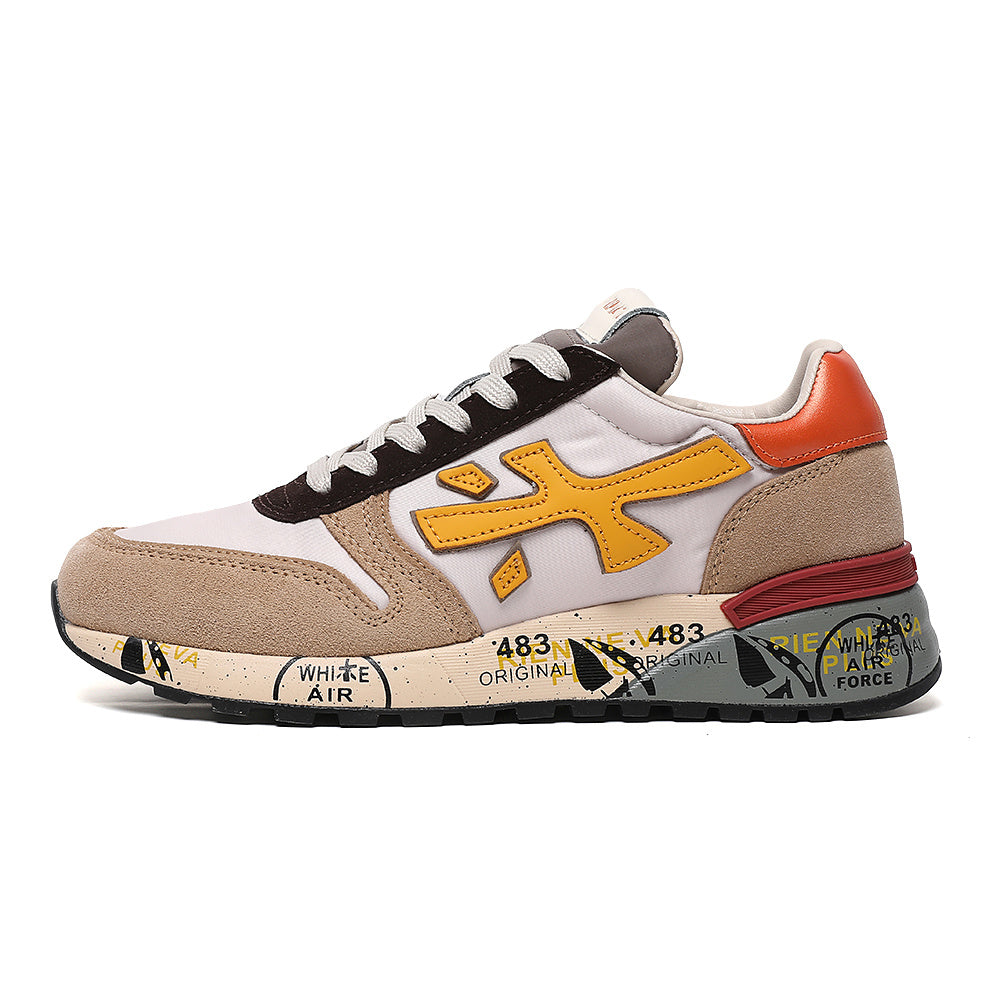Side view of white and tan low-top sneakers with yellow side detail, red heel accent, and printed outsole graphics.