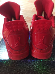 Rear view of red high-top sneakers showing the raised heel logo detail.