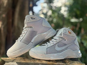 Angled view of the gray and off-white high-top sneakers with side Swoosh branding and textured uppers.