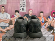 Rear view of the matching black sneakers showing padded collars and glossy heel panels.