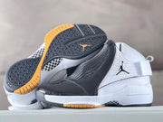 Pair of white and black high-top sneakers displayed with their patterned black outsole and gum-colored tread.